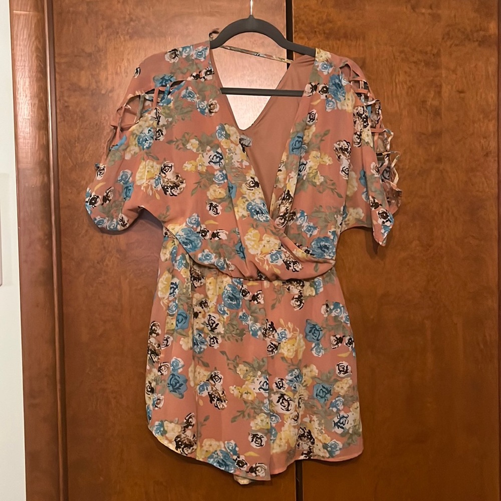 pink romper with floral patterns